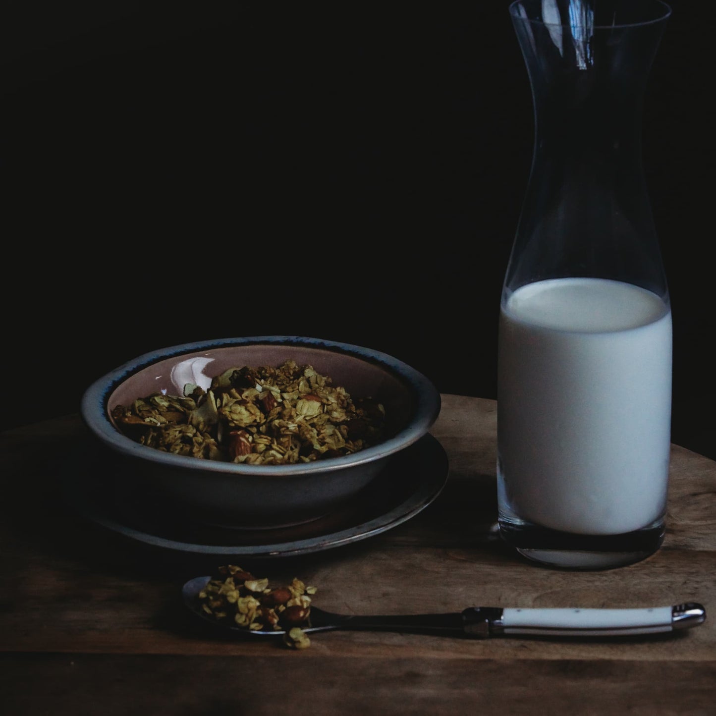 Bowls of red lime jones granola with milk