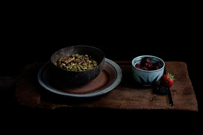 Bowl of Red Lime Jones I am nuts granola with berries on table